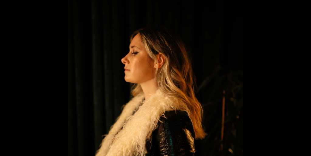 Sorcha Durham in profile, with eyes closed and dramatic lighting